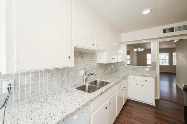 a kitchen with a sink stove and cabinets