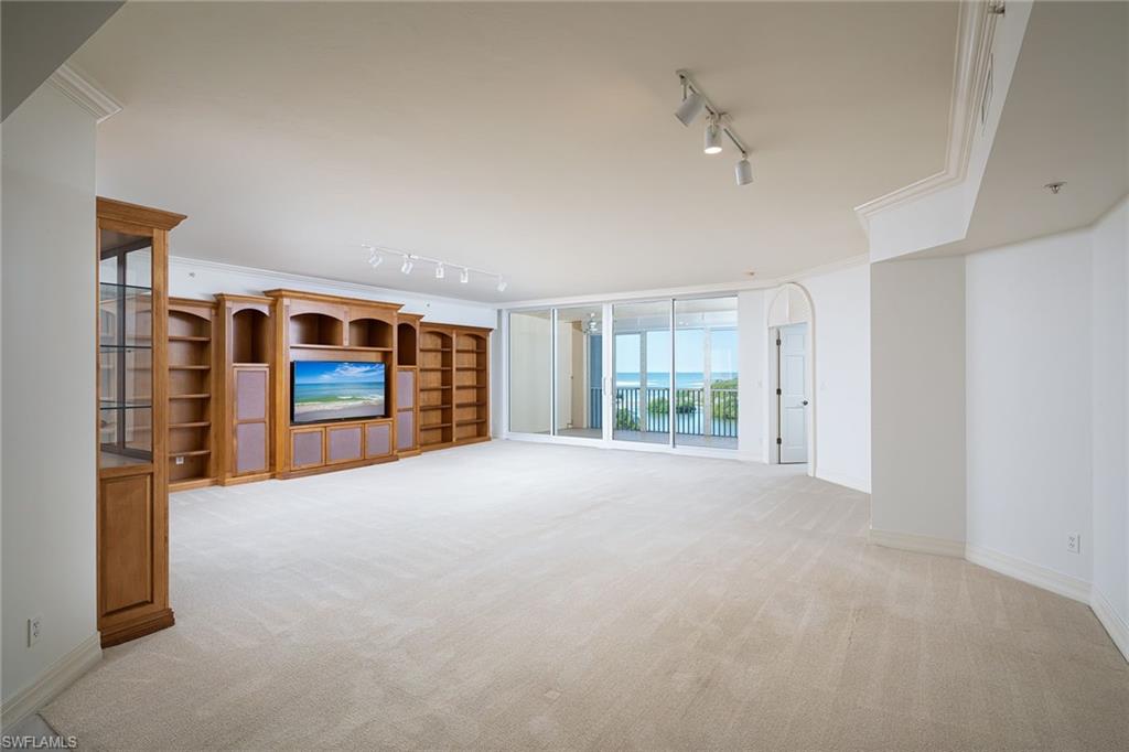435 Dockside Drive, Unit B703 Naples, FL 34110 - Photo 2 of 38 a view of an empty room with a window and a kitchen