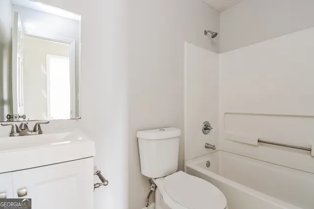 a bathroom with a toilet sink and bathtub
