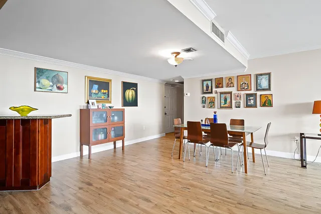 a view of a dining room with furniture and wooden floor