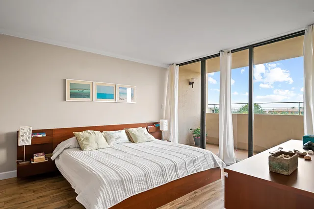 a bedroom with a large bed and a large window