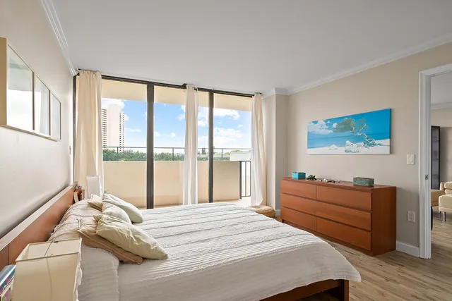 a bedroom with a bed and glass window