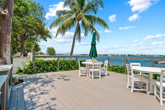 a view of a patio with a table and chairs and potted plants