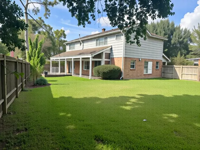 a view of a house with a yard and sitting area