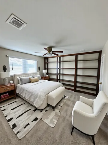 a spacious bedroom with a bed and a couch