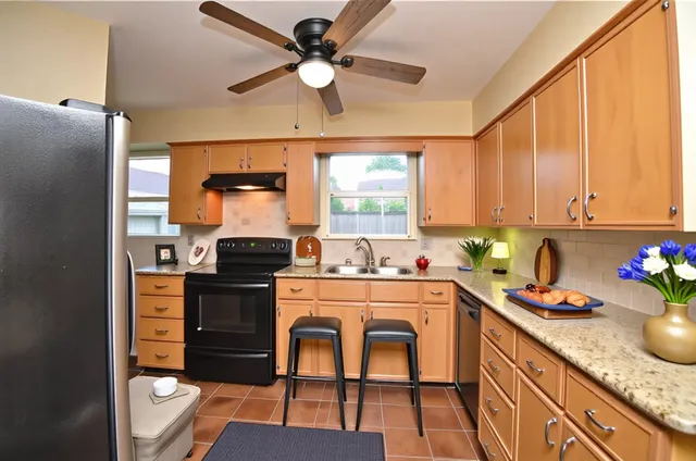 a kitchen with a stove a refrigerator and a sink