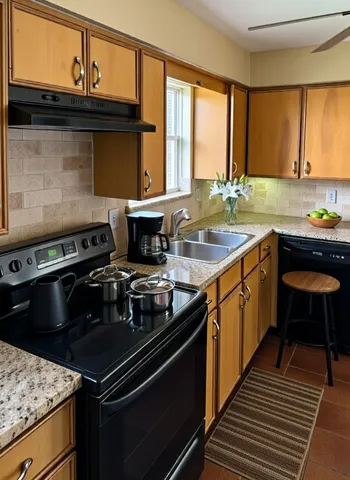 a kitchen with a stove and a sink