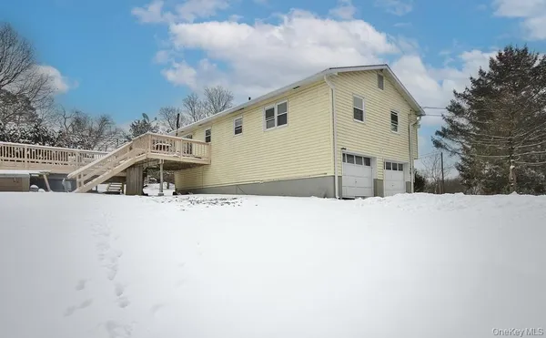 a view of a house with a snow in the yard