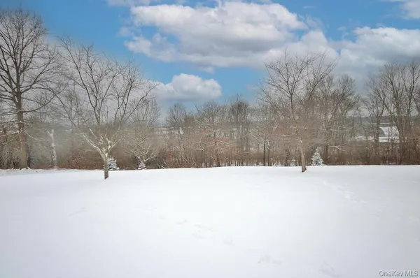 a white house covered with snow in front of house