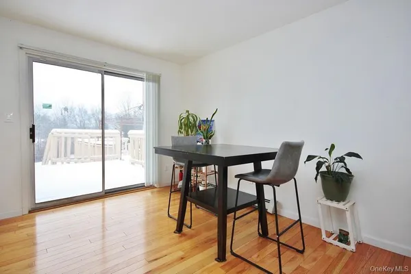 a view of a workspace room with wooden floor and furniture