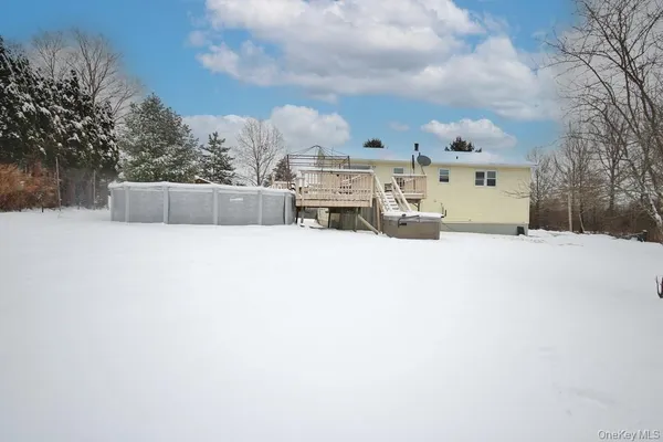 a view of swimming pool with a yard and covered with snow