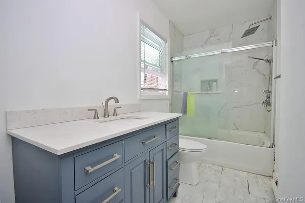 a view of a bathroom with a glass door shower and a sink