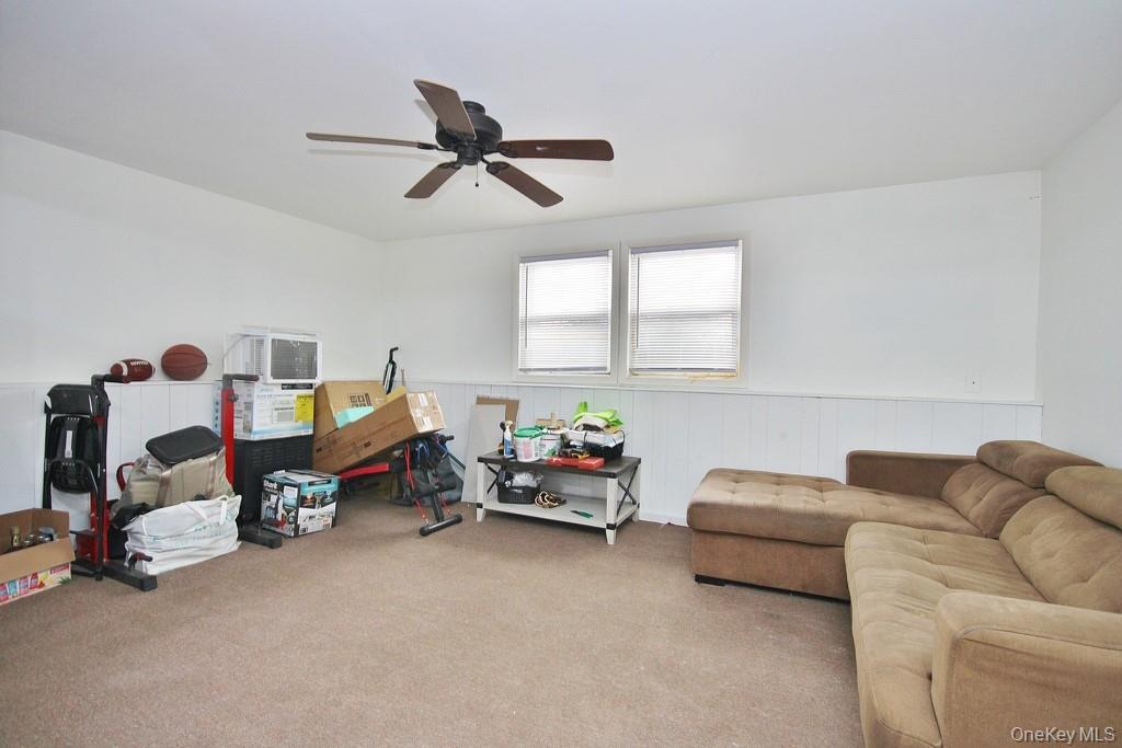 1065 Dolsontown Road Middletown, NY 10940 - Photo 44 of 50 a living room with furniture and a chandelier