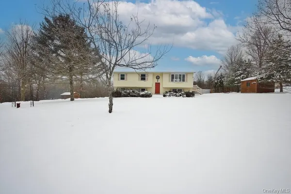 a view of a building with snow on the road