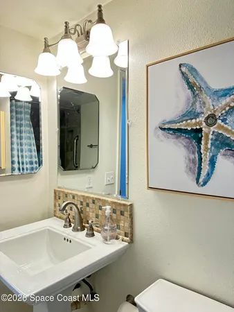 a bathroom with a sink mirror and vanity