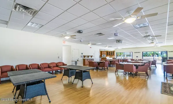 a living room with lots of furniture and a wooden floor