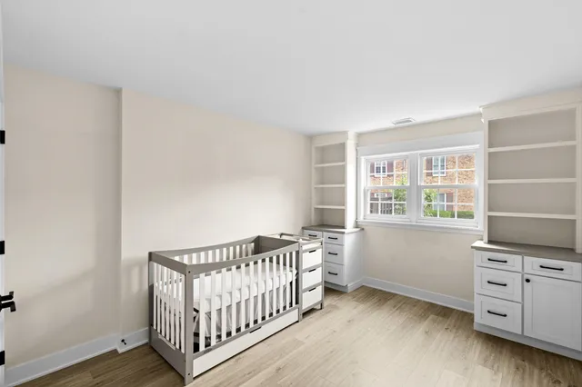 a view of a bedroom with furniture and windows