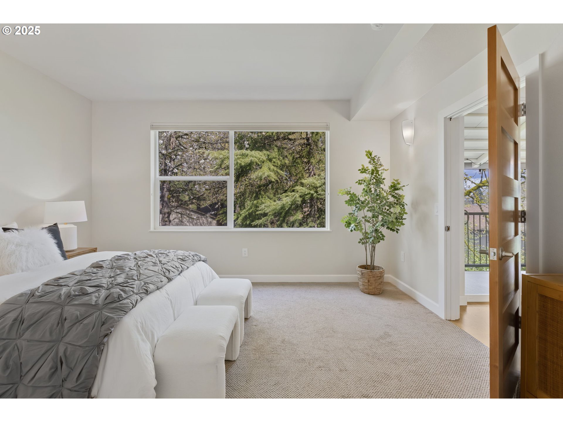347 Rustic Place, Unit 24 Eugene, OR 97401 - Photo 20 of 42 a bedroom with a large bed and a large window