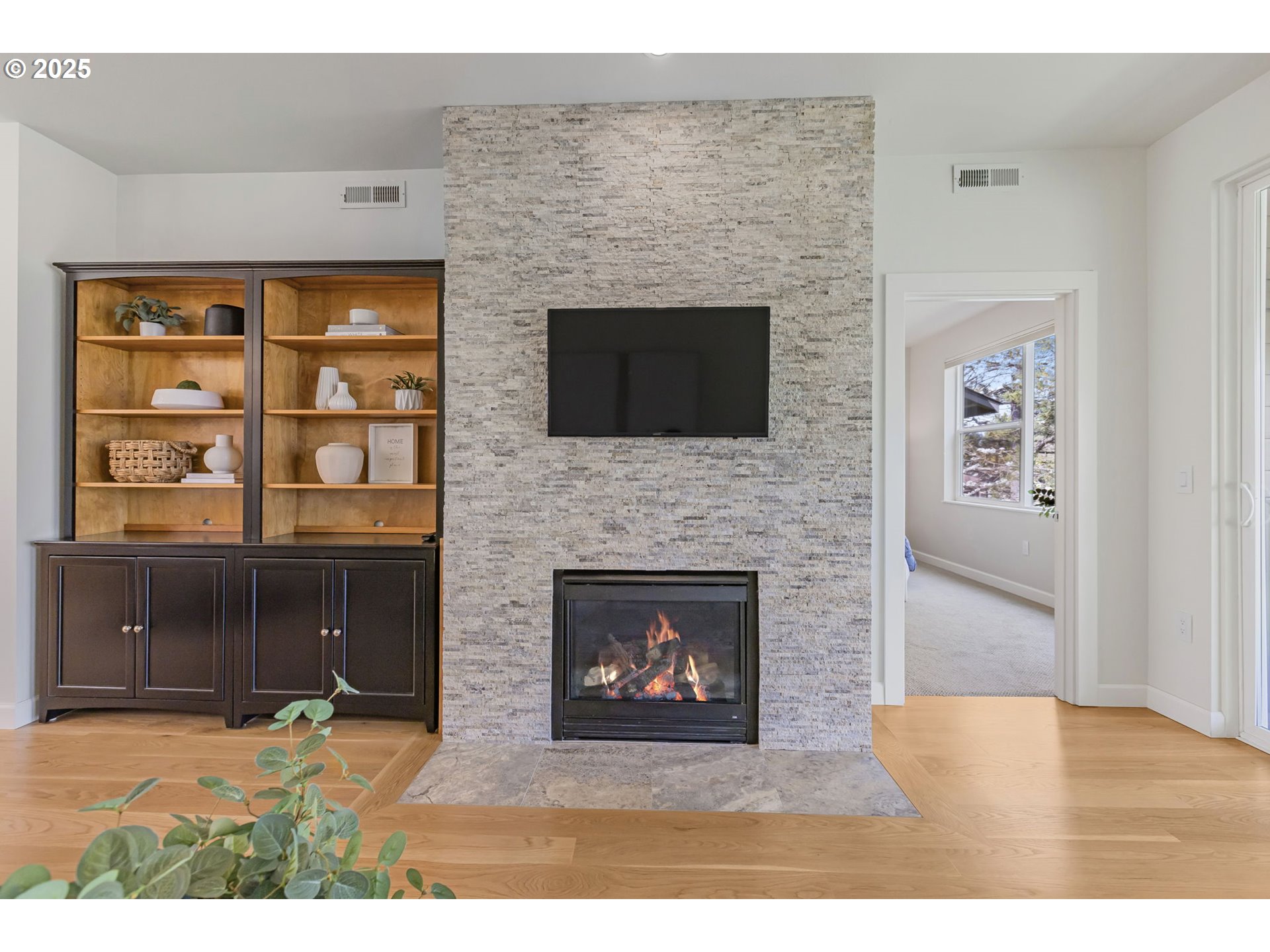 347 Rustic Place, Unit 24 Eugene, OR 97401 - Photo 8 of 42 a living room with a fireplace a flat screen tv and a fireplace