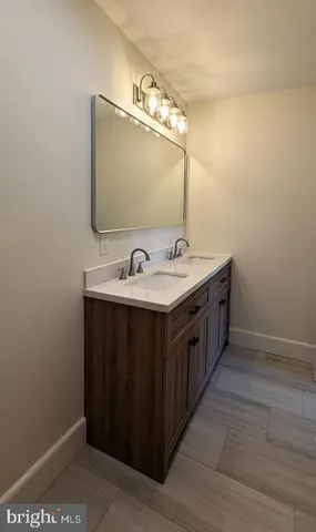 a bathroom with a double vanity sink and mirror