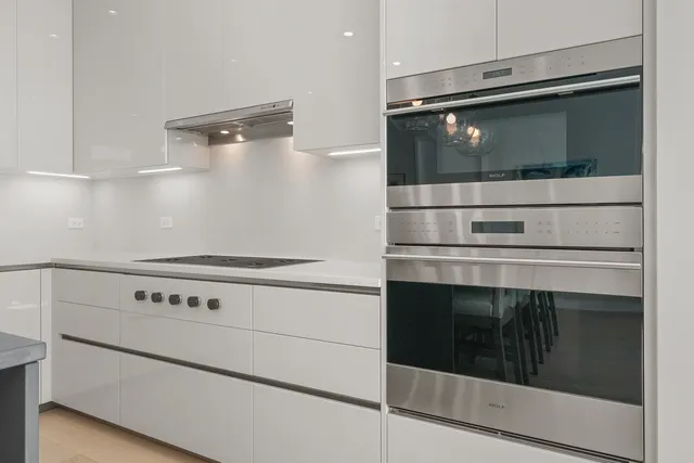 a stove top oven sitting inside of a kitchen