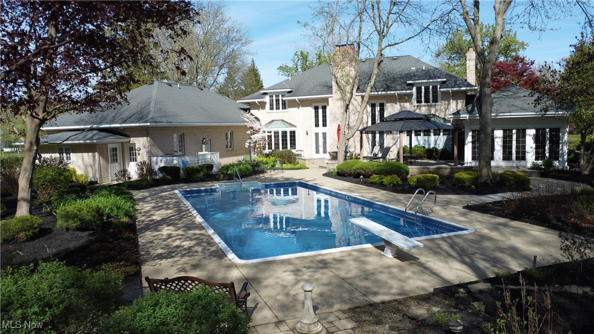 9870 Hobart Road Willoughby, OH 44094 - Photo 47 of 50 Rear view of house with french doors, a chimney, an outdoor pool, a gazebo, and a patio
