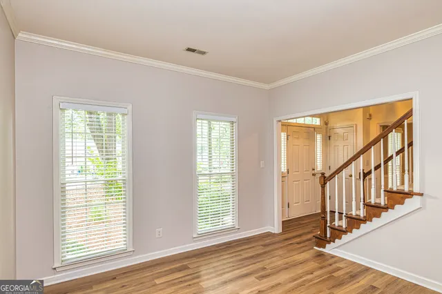 an empty room with a empty space and windows