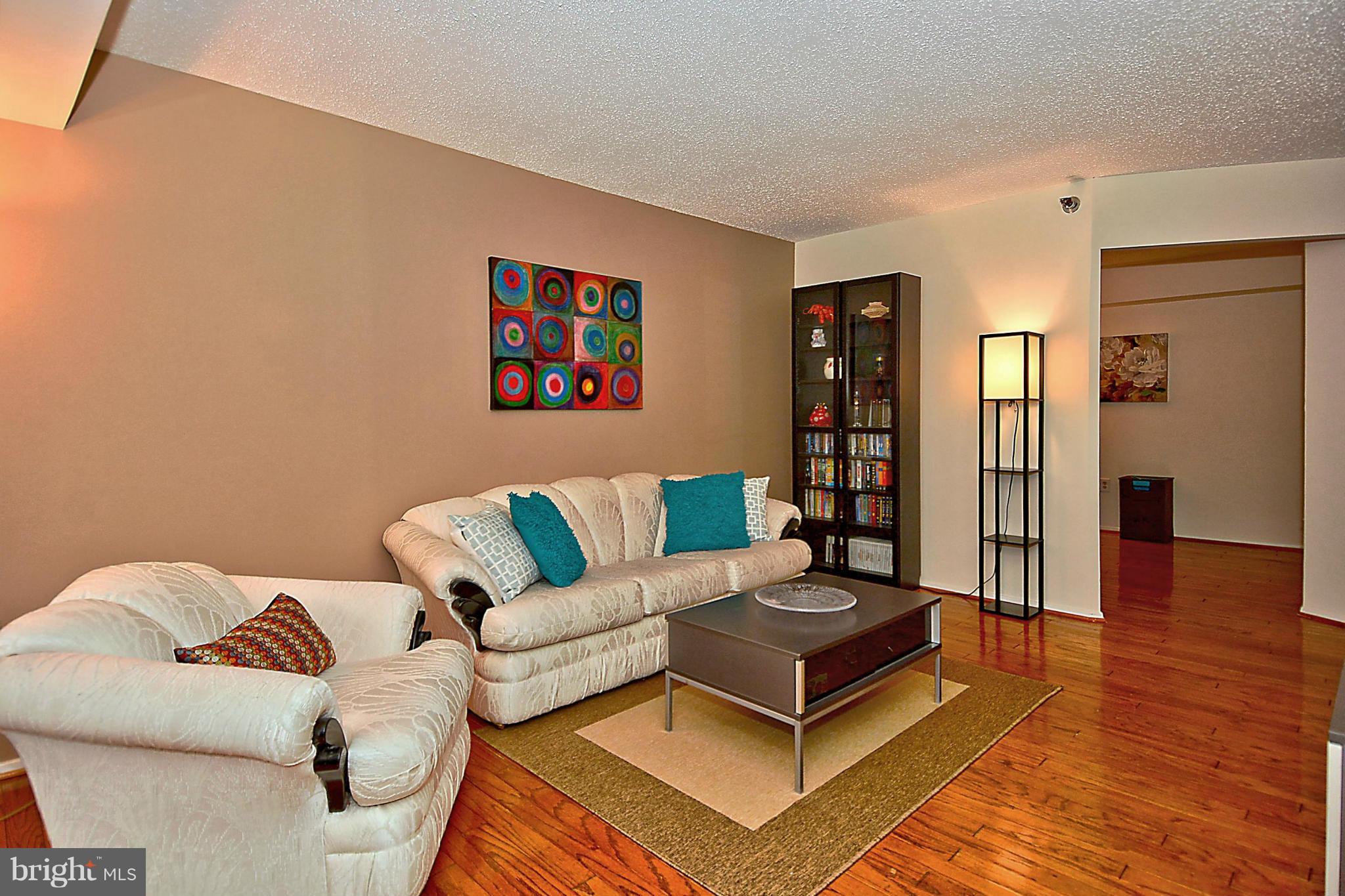 1808 Old Meadow Road, Unit 217 McLean, VA 22102 - Photo 30 of 30 a living room with furniture and wooden floor