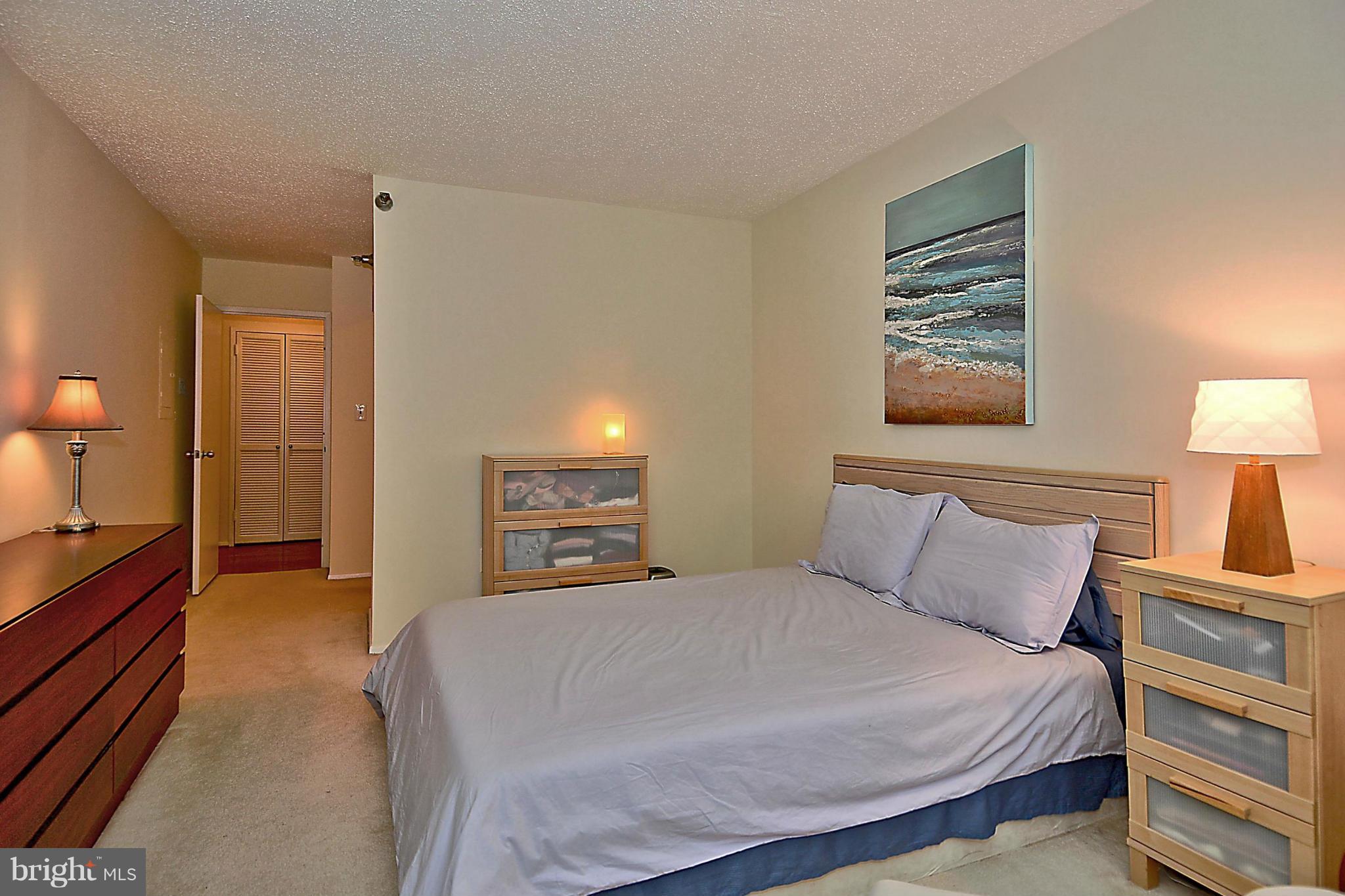 1808 Old Meadow Road, Unit 217 McLean, VA 22102 - Photo 11 of 30 a bedroom with a bed and a lamp