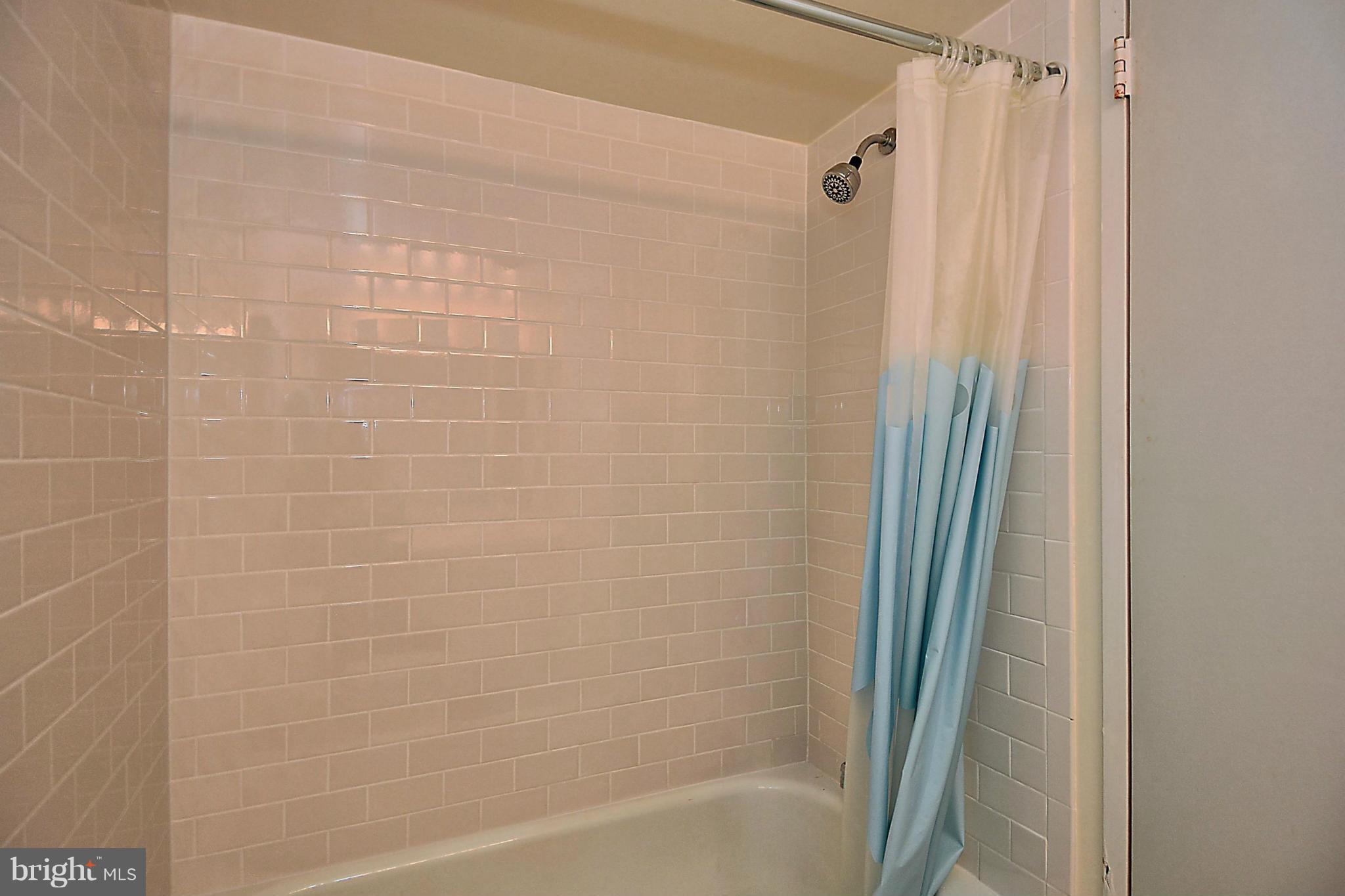 1808 Old Meadow Road, Unit 217 McLean, VA 22102 - Photo 14 of 30 a bathroom with a shower and a tub