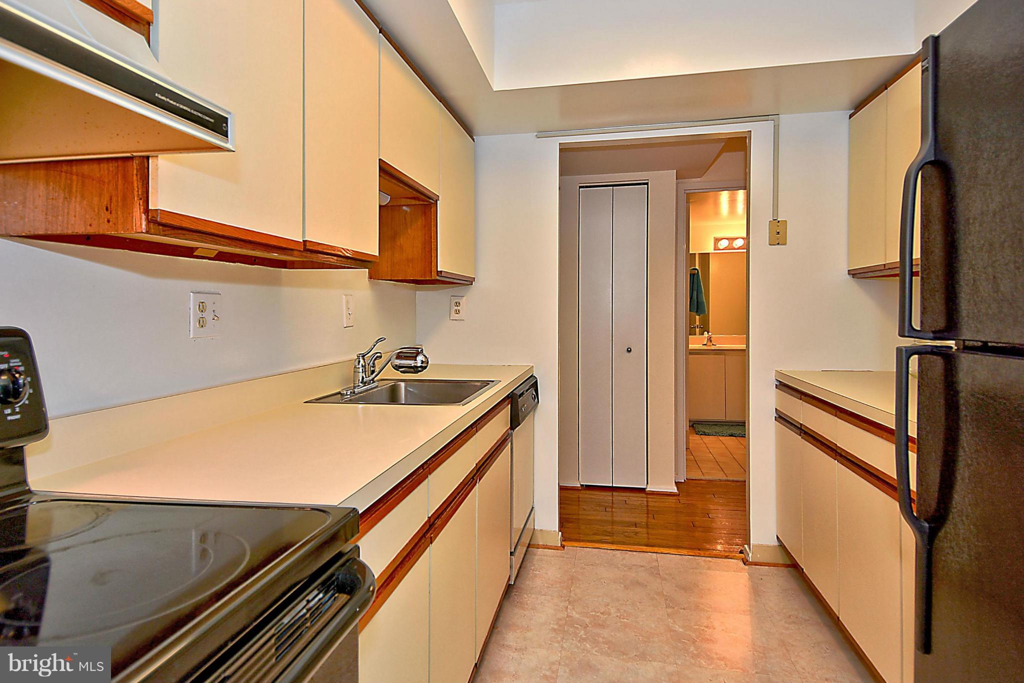 1808 Old Meadow Road, Unit 217 McLean, VA 22102 - Photo 16 of 30 a kitchen with stainless steel appliances a refrigerator and a stove