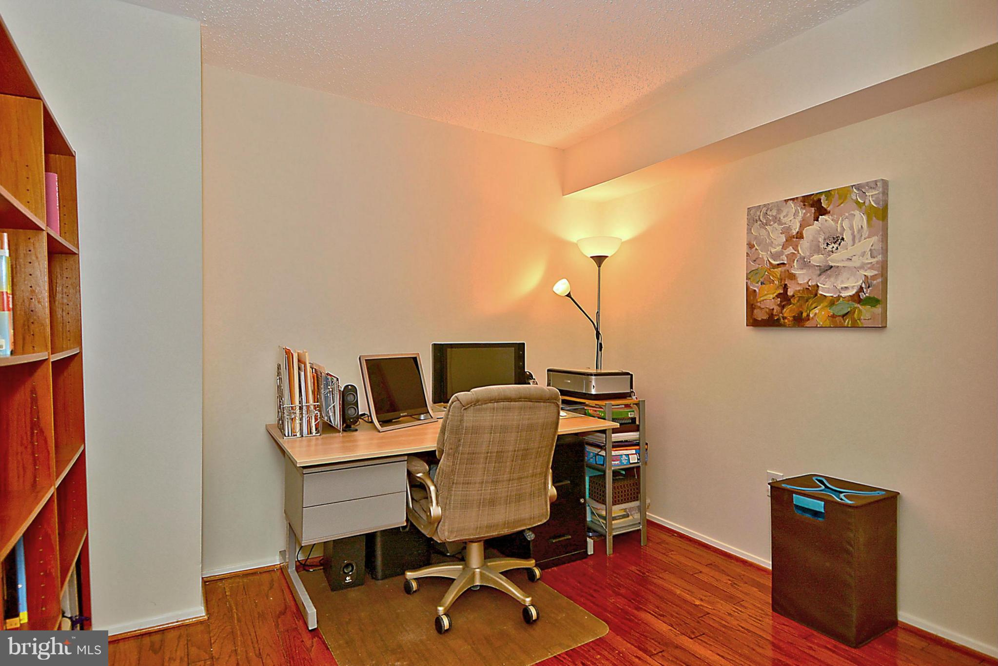 1808 Old Meadow Road, Unit 217 McLean, VA 22102 - Photo 2 of 30 a workspace with furniture and wooden floor