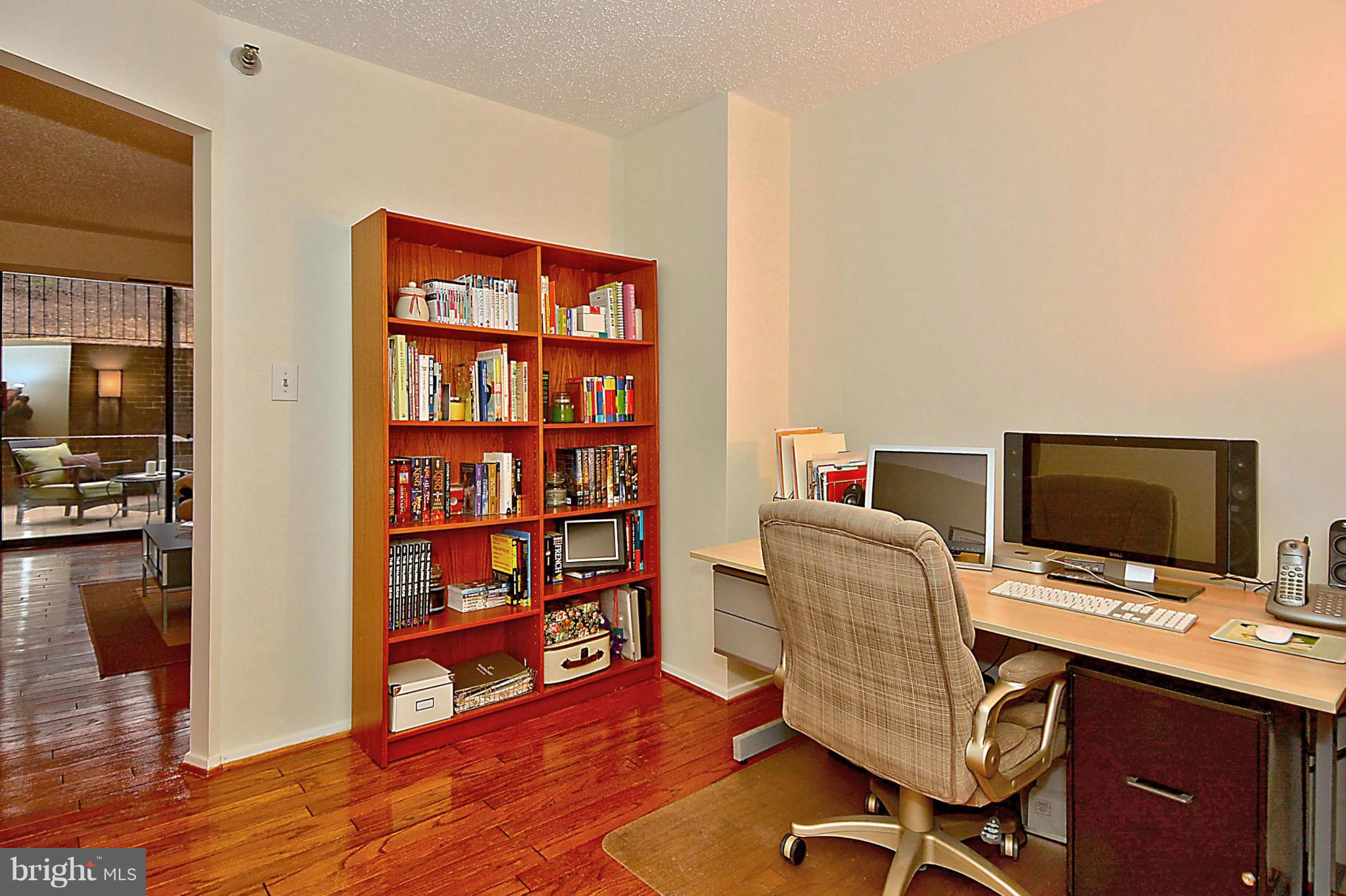 1808 Old Meadow Road, Unit 217 McLean, VA 22102 - Photo 3 of 30 a view of a workspace with furniture and wooden floor