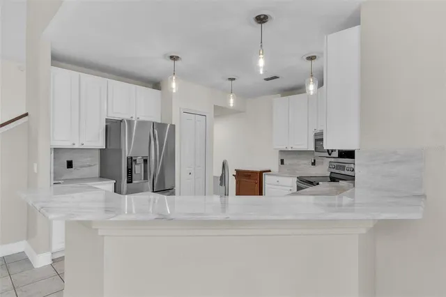 a spacious bathroom with a double vanity sink a mirror and a bathtub