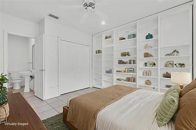 an empty room with wooden floor and a ceiling fan