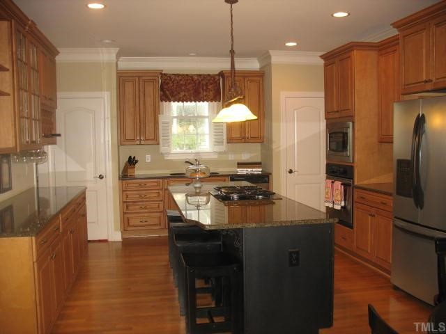 10311 Evergreen Spring Place Raleigh, NC 27614 - Photo 3 of 12 This view of the kitchen is from the famly room/breakfast room area. The island doubles as a breakfast bar.