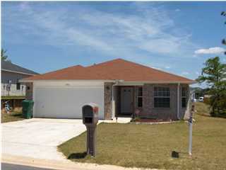 133 Sandstone Trail Crestview, FL 32539 - Photo 1 of 9 a front view of a house with a yard and garage