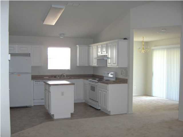 133 Sandstone Trail Crestview, FL 32539 - Photo 3 of 9 a kitchen with granite countertop a sink and a stove