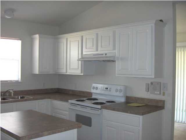 133 Sandstone Trail Crestview, FL 32539 - Photo 4 of 9 a kitchen with granite countertop white cabinets and a sink