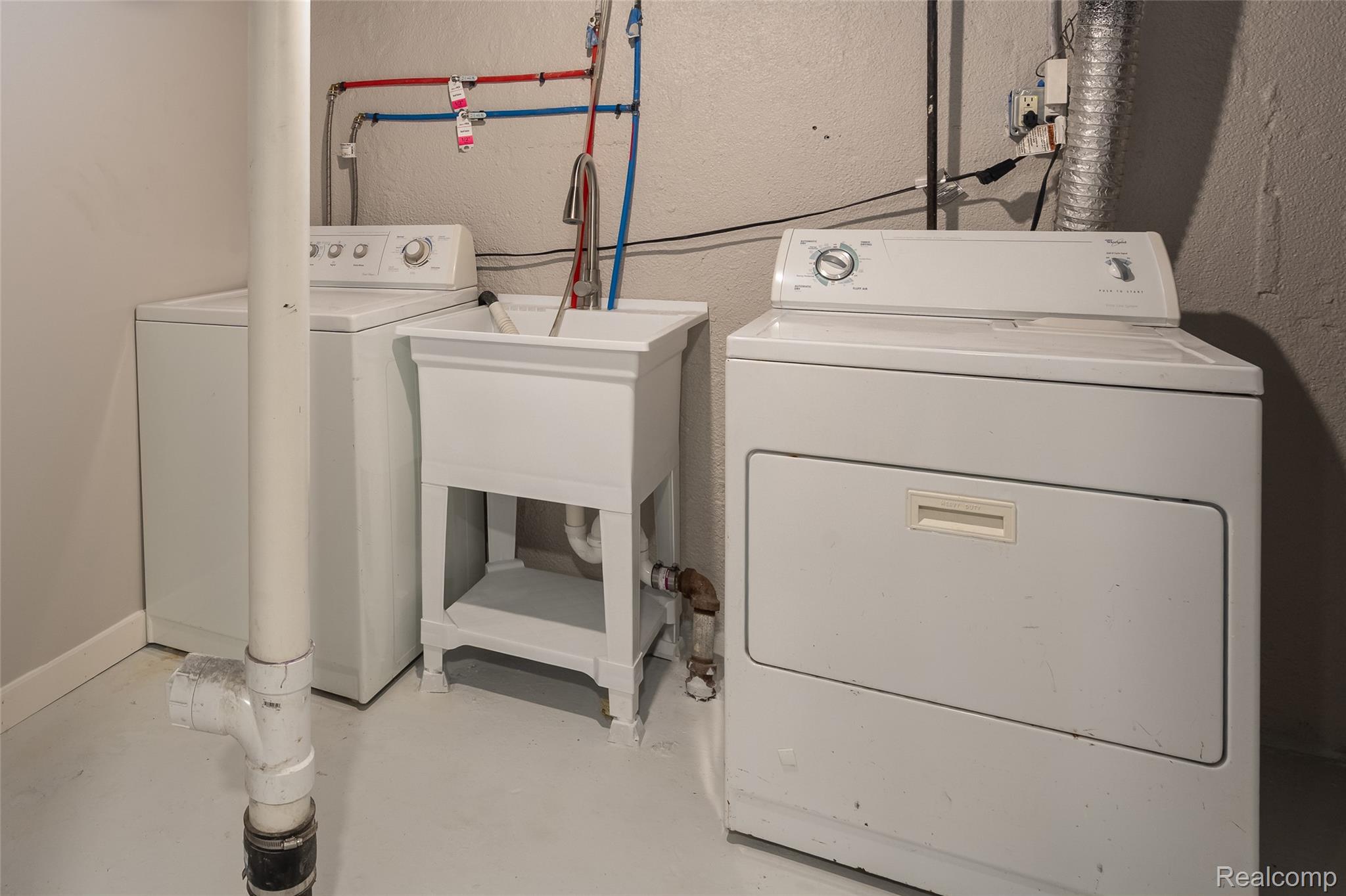 201 Cardwell Street Inkster, MI 48141 - Photo 36 of 41 Dedicated laundry area featuring a utility sink, washer, and dryer