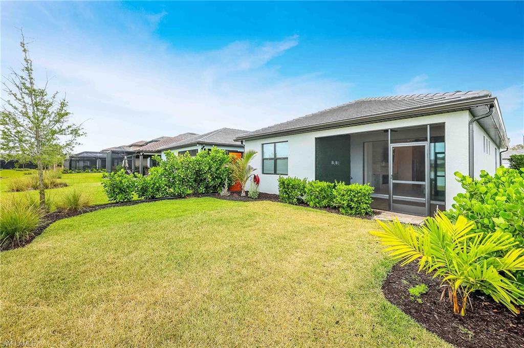 2179 Yellowfin Circle Naples, FL 34114 - Photo 2 of 20 a house with a garden view