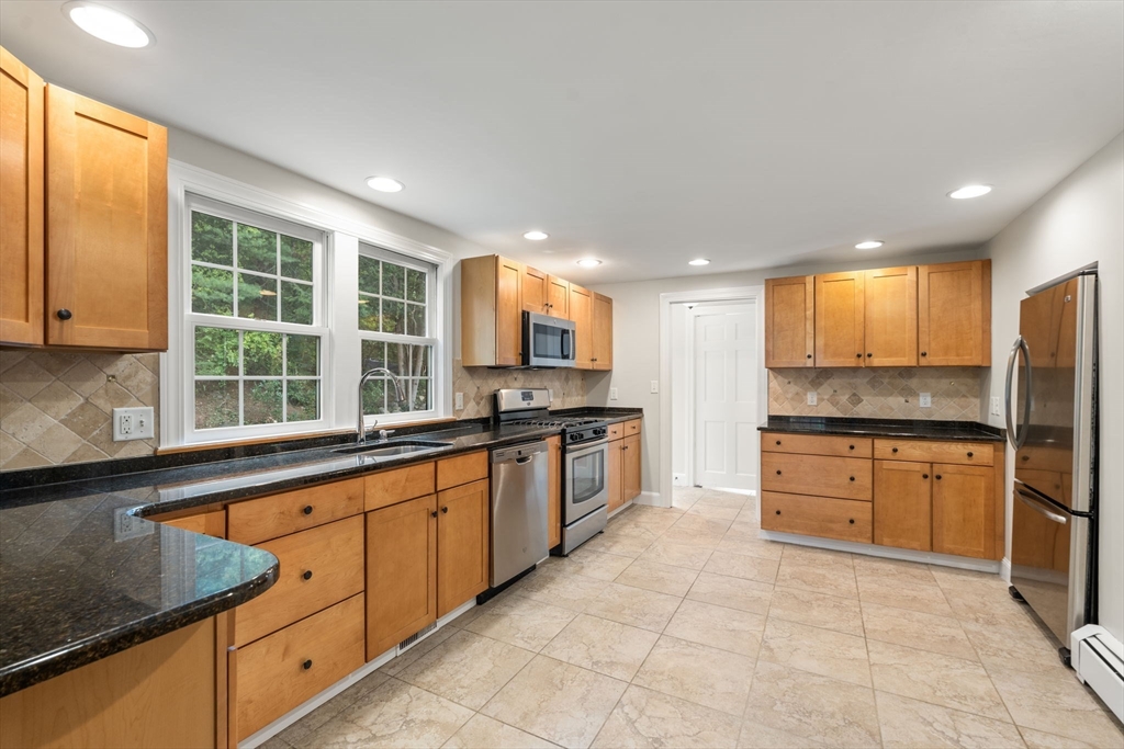 92 Abbot Street Andover, MA 01810 - Photo 7 of 35 a large kitchen with stainless steel appliances granite countertop a stove a sink and a refrigerator
