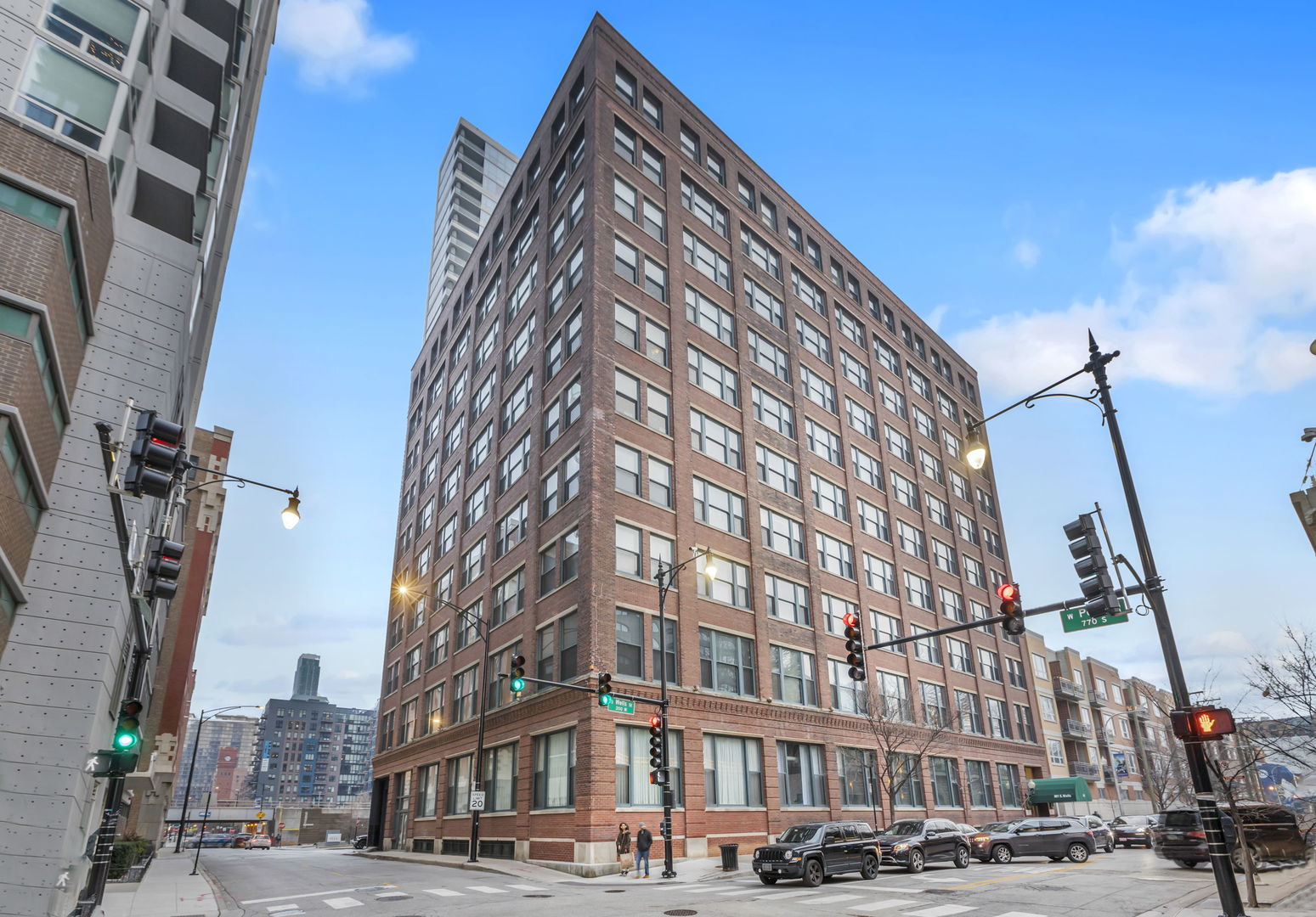 a view of a tall building next to a road