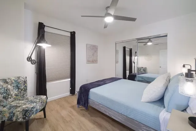 a living room with furniture a large window with wooden floor