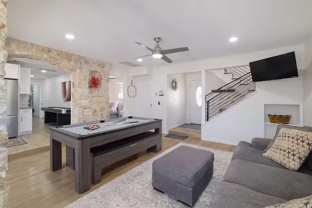 a living room with furniture and a chandelier