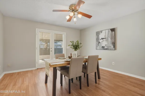 a view of a dining room with furniture wooden floor and chandelier