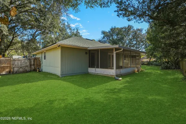 a view of a house with a backyard