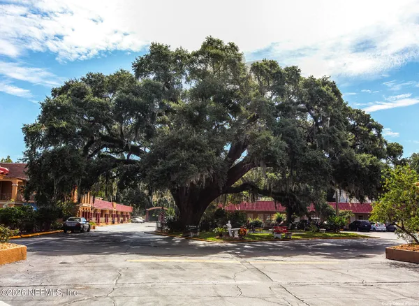 a sign board with buildings in the background