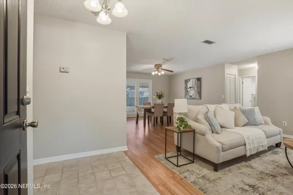 a kitchen with granite countertop a refrigerator and a table chair