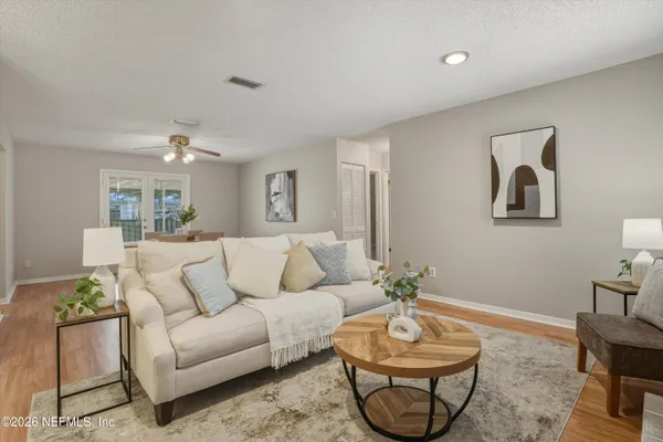 a living room with furniture and a chandelier